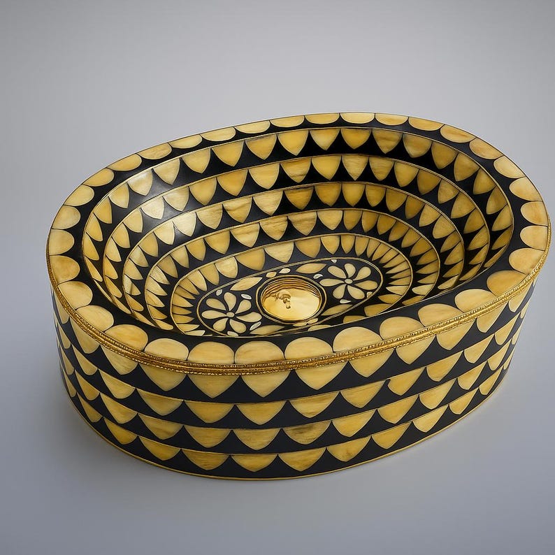 Artisan oval brass vessel sink with black, bone & resin inlay. Handcrafted for luxury bathrooms, spas, and designer vanities. Includes brass drain.

