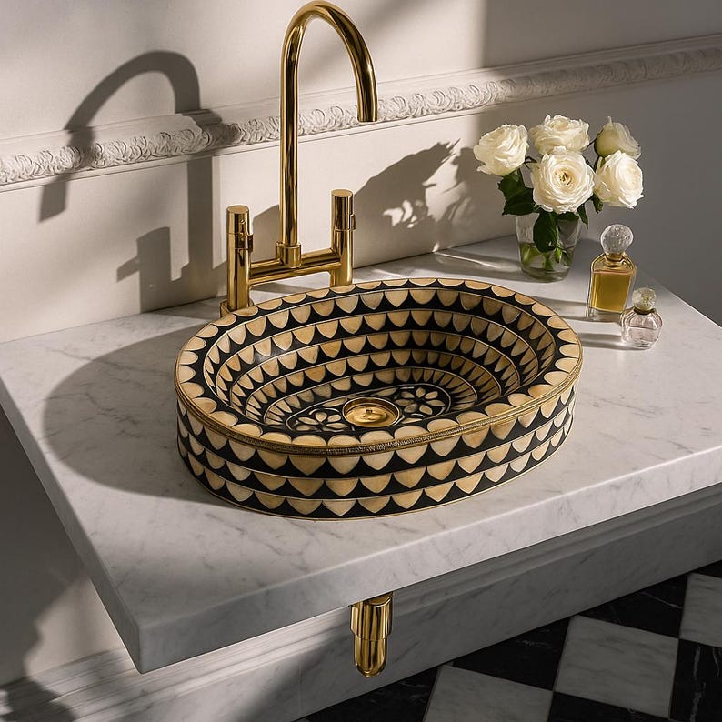 Artisan oval brass vessel sink with black, bone & resin inlay. Handcrafted for luxury bathrooms, spas, and designer vanities. Includes brass drain.

