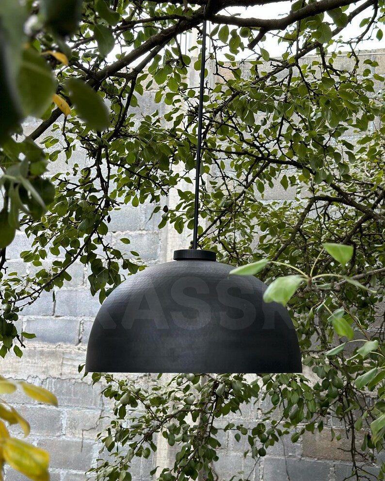 Black and copper dome pendant light above kitchen island

