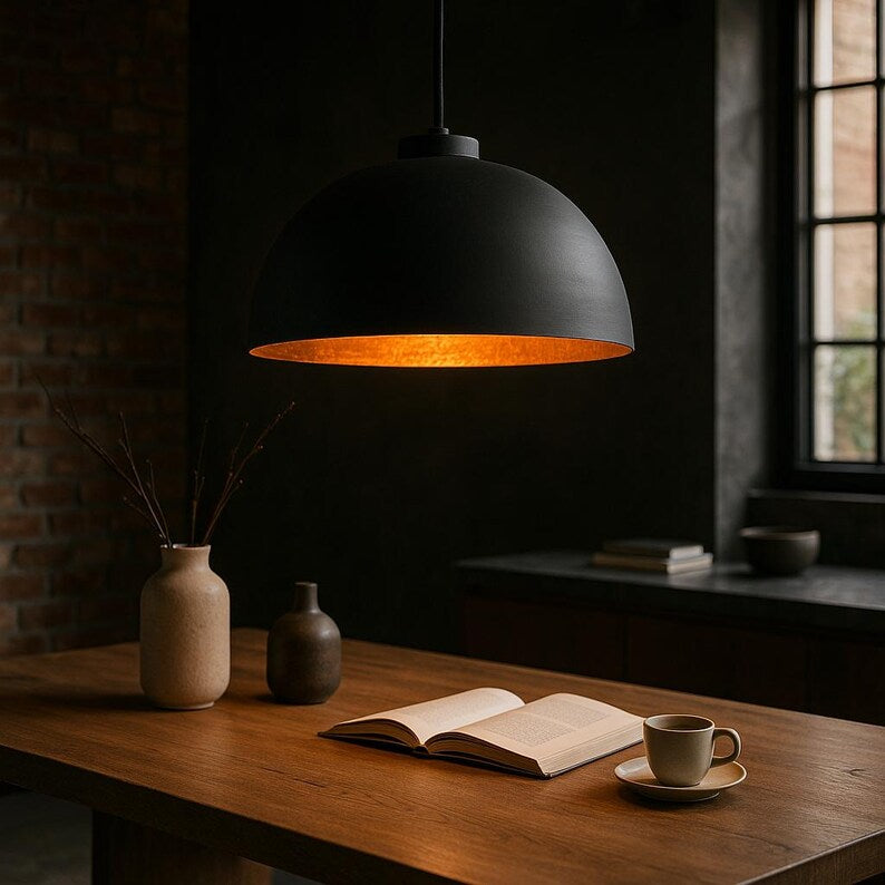 Black and copper dome pendant light above kitchen island

