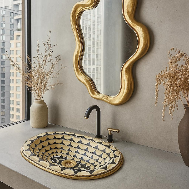Black brass oval drop-in sink with bone and resin inlay