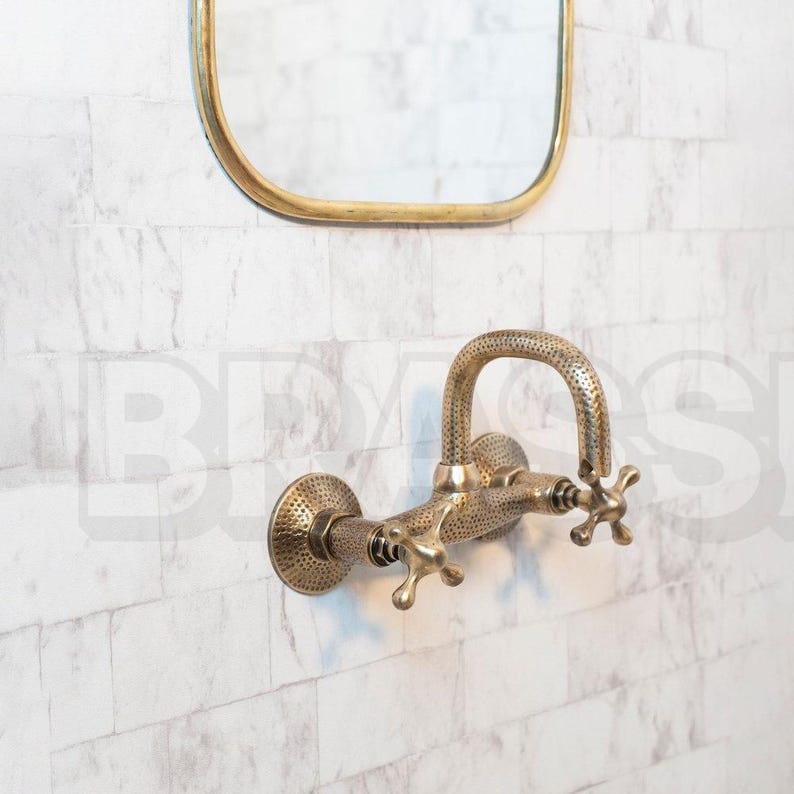 Hand-hammered brass wall mount bathroom faucet with oil-rubbed finish and vintage cross handles

