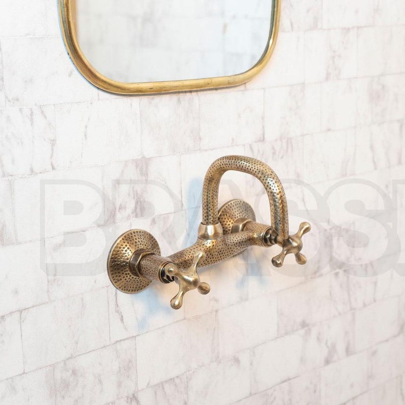 Hand-hammered brass wall mount bathroom faucet with oil-rubbed finish and vintage cross handles

