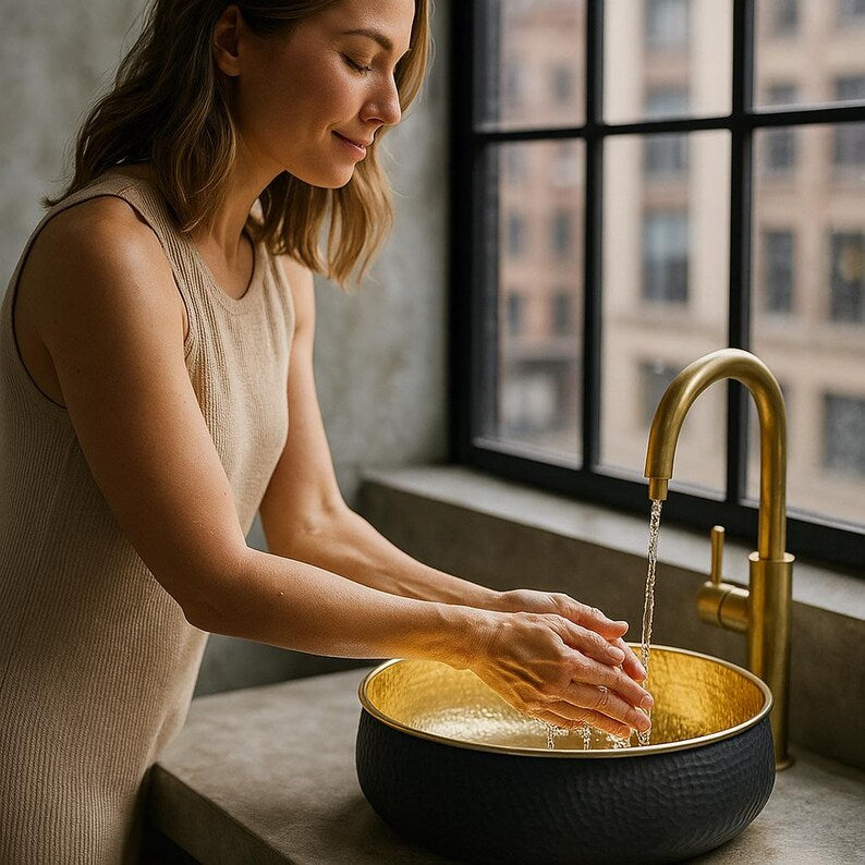 Hand-hammered round brass vessel sink with polished gold interior