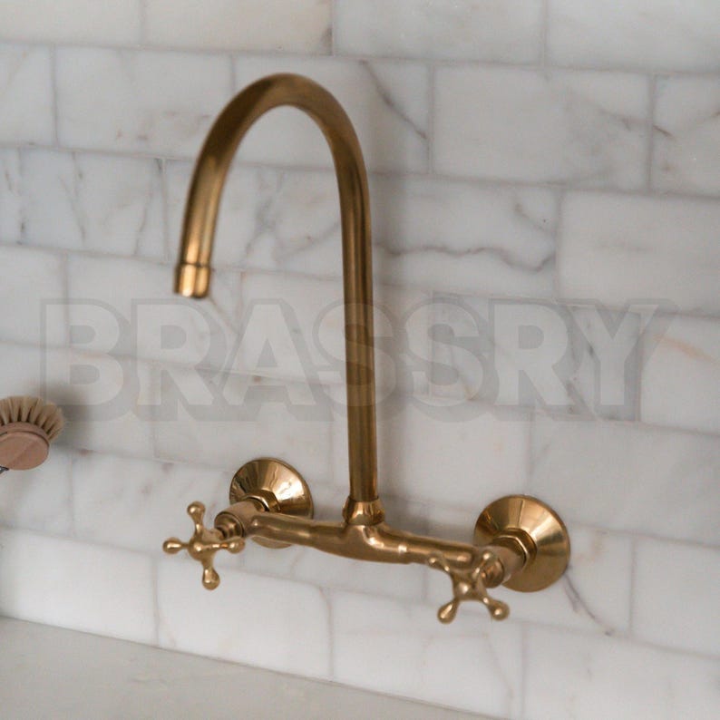 Handmade Moroccan wall-mount faucet in solid unlacquered brass with gooseneck spout and cross handles

