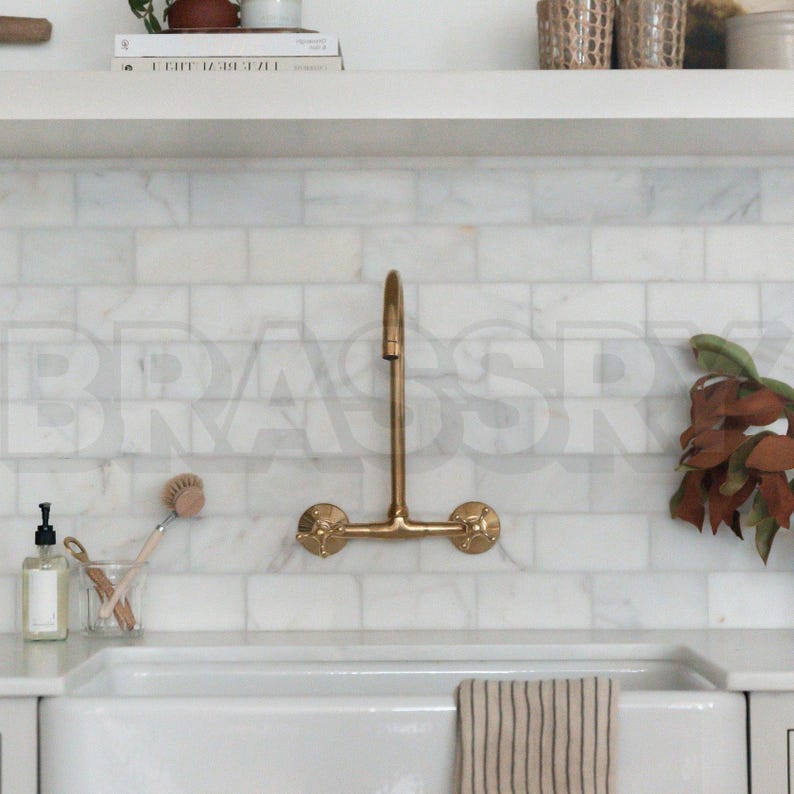 Handmade Moroccan wall-mount faucet in solid unlacquered brass with gooseneck spout and cross handles

