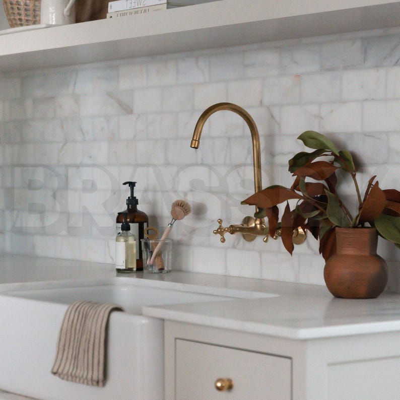 Handmade Moroccan wall-mount faucet in solid unlacquered brass with gooseneck spout and cross handles

