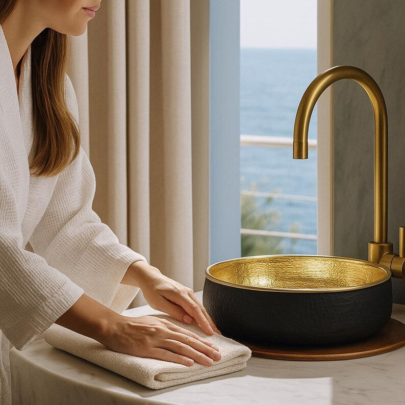 Handmade bathroom vessel sink with matte black exterior and gold finish
