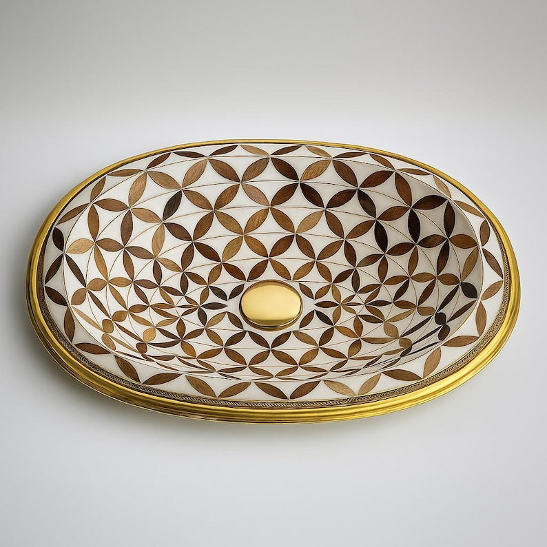 Handmade brass oval bathroom sink with flower inlay in bone and wood on white base

