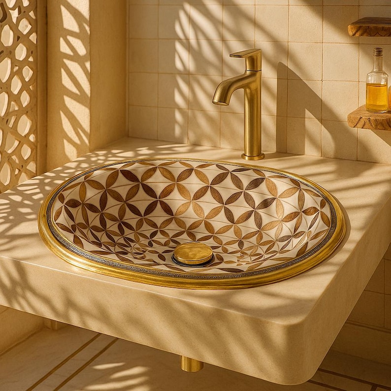 Handmade brass oval bathroom sink with flower inlay in bone and wood on white base

