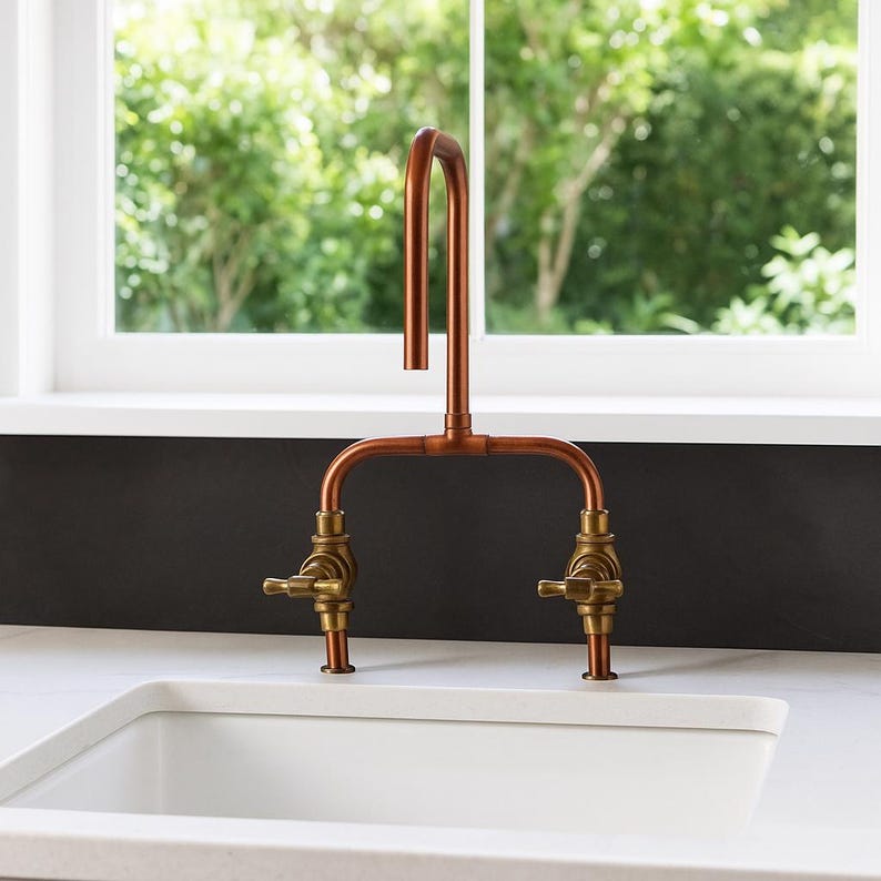 Handmade copper and brass faucet with U-shaped spout

