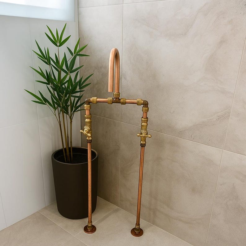 Handmade freestanding copper bath filler with brass taps

