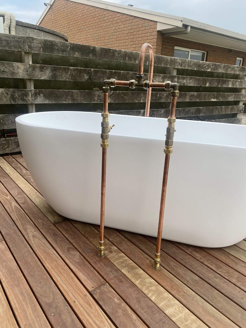 Handmade freestanding copper bath filler with brass taps


