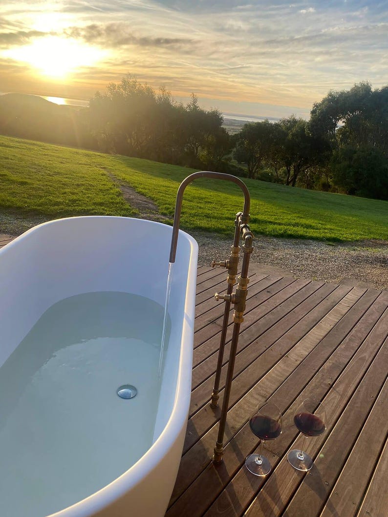 Handmade freestanding copper bath filler with brass taps

