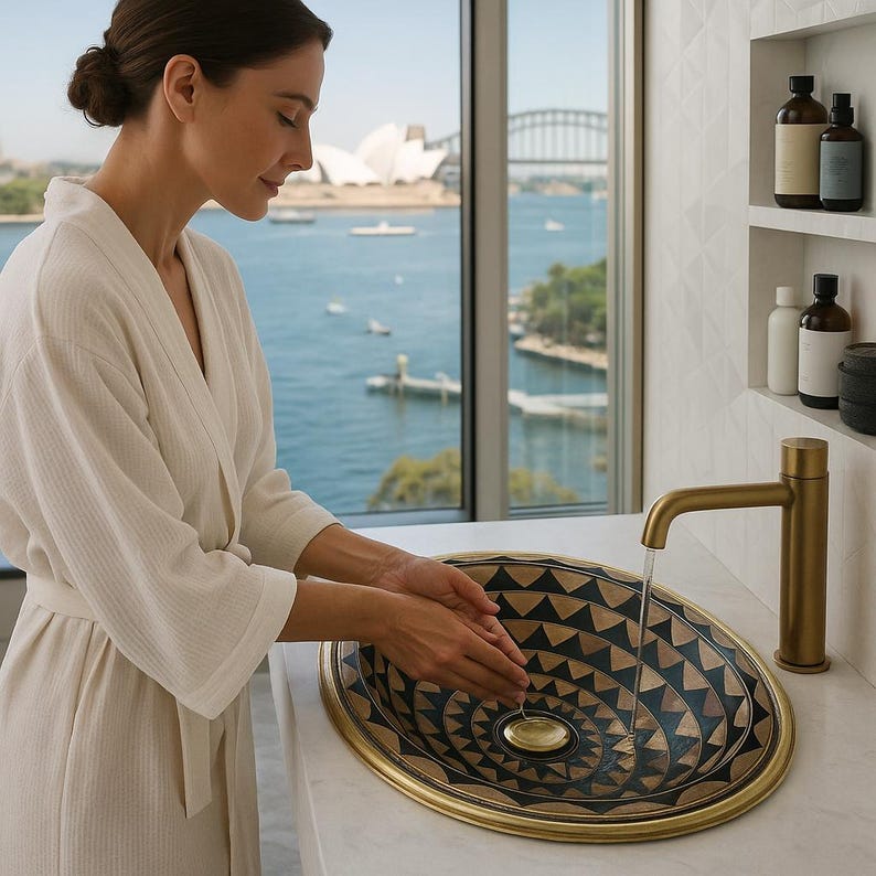 Handmade oval brass bathroom sink with black resin and bone inlay

