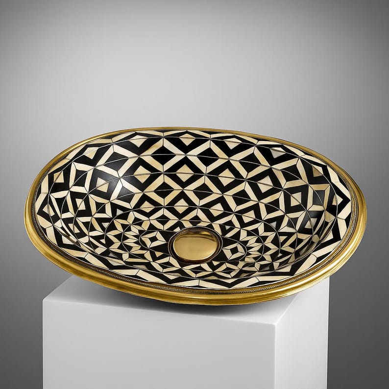 Handmade oval brass bathroom sink with bone and resin flower pattern inlay on black base

