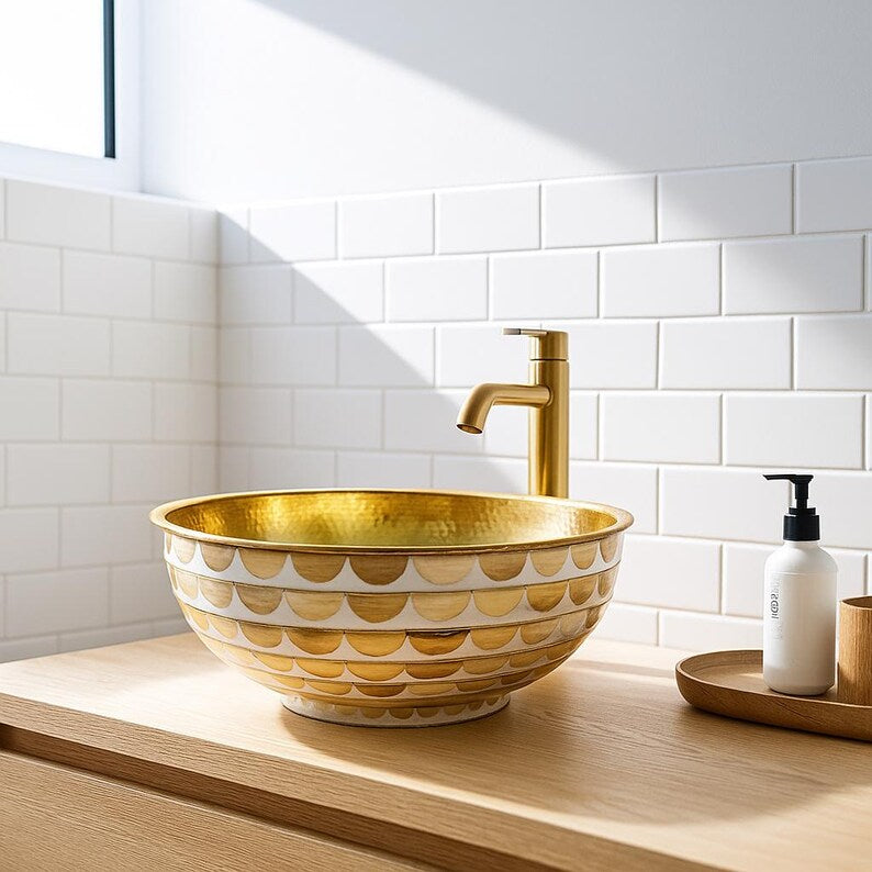 Handmade round brass vessel sink with hammered gold interior and ivory-toned wood inlays – countertop bathroom basin

