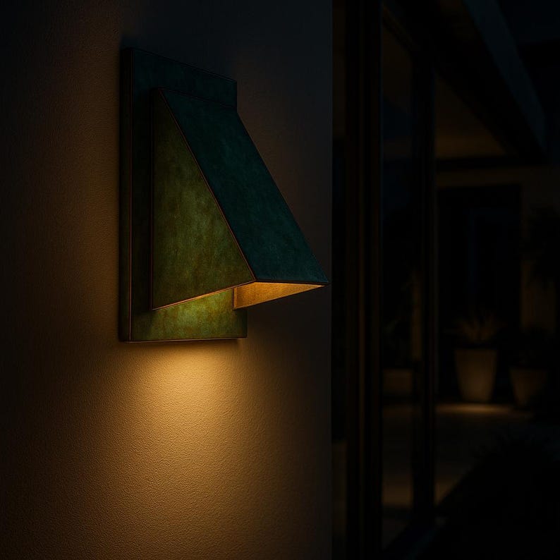  Indoor decorative brass sconce with oxidized green finish and sculptural shape