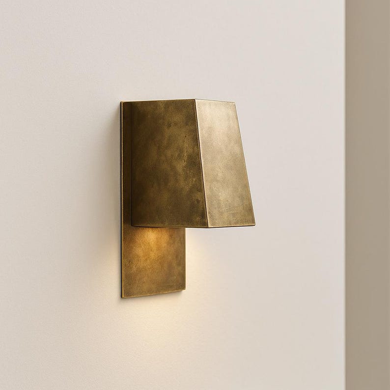 Modern brass lighting fixture with angular shape and natural patina