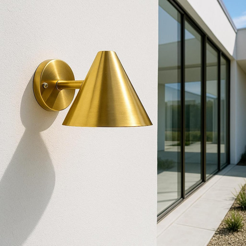 Modern brass wall sconce for patio or entryway – golden light for architectural settings

