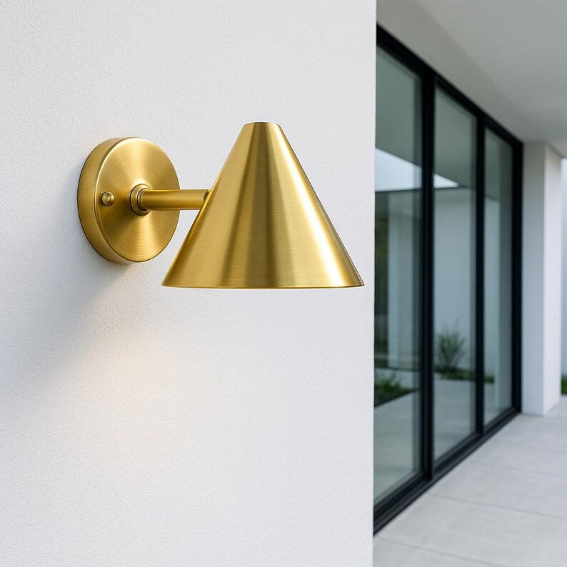 Modern brass wall sconce for patio or entryway – golden light for architectural settings

