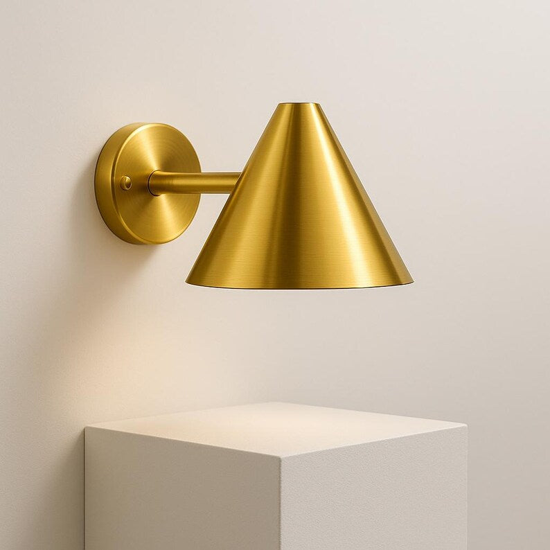 Modern brass wall sconce for patio or entryway – golden light for architectural settings


