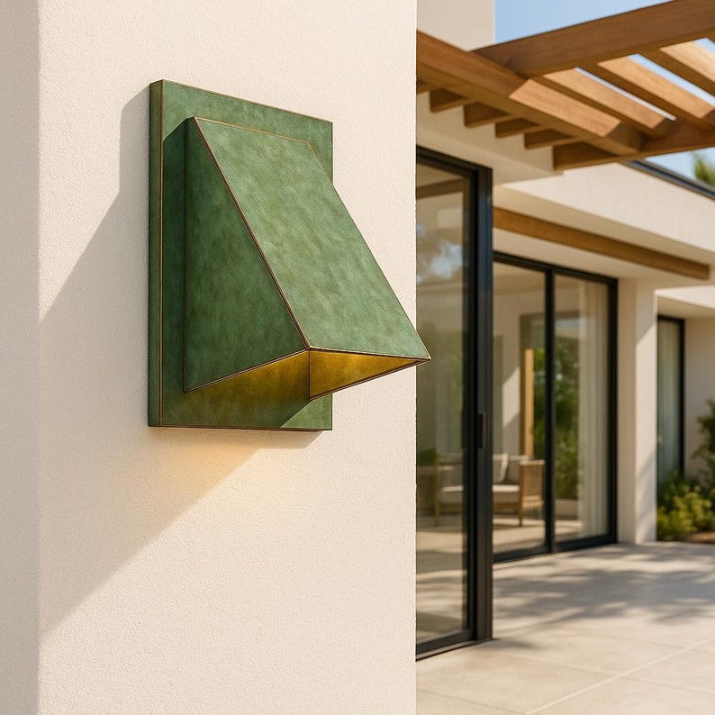 Modern geometric brass sconce with natural patina finish for indoor lighting