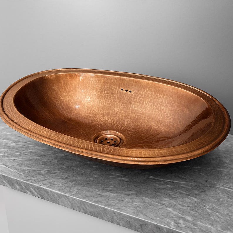 Oval hammered copper drop-in sink for farmhouse bathroom

