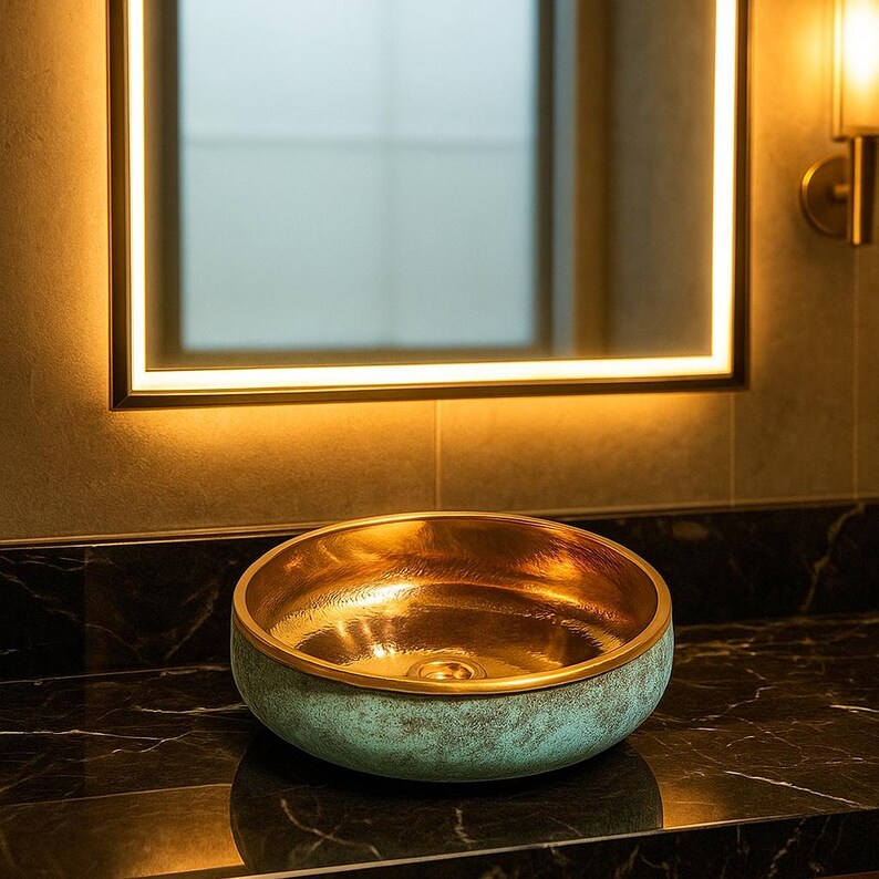 Round bathroom basin with oxidized copper and golden brass interior