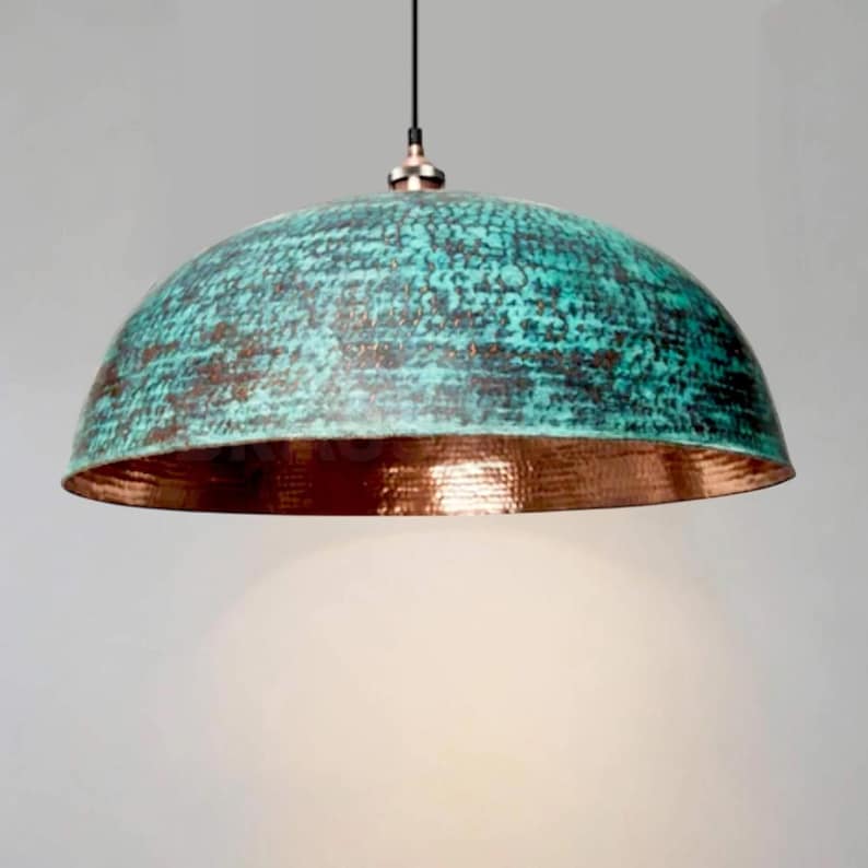 Rusted Moroccan hammered copper pendant light over kitchen island

