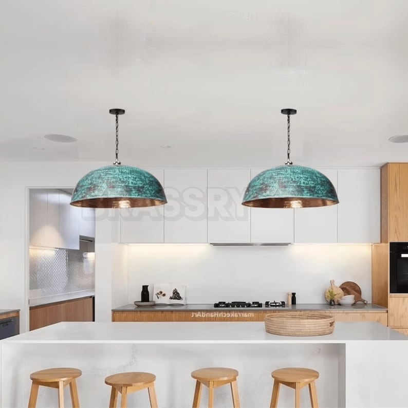 Rusted Moroccan hammered copper pendant light over kitchen island
