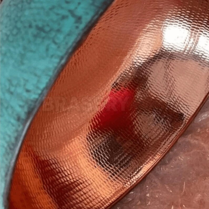 Rusted Moroccan hammered copper pendant light over kitchen island

