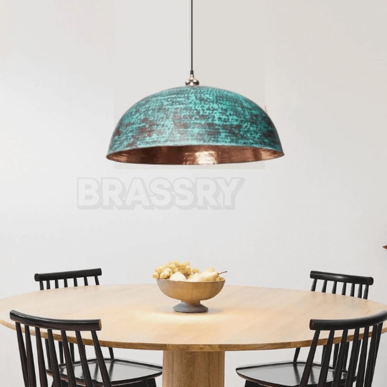 Rusted Moroccan hammered copper pendant light over kitchen island
