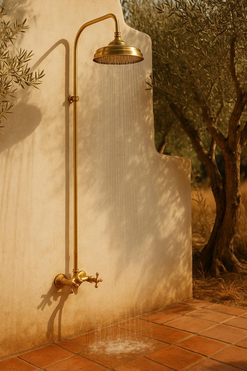 Rustic bathroom featuring handcrafted unlacquered brass shower

