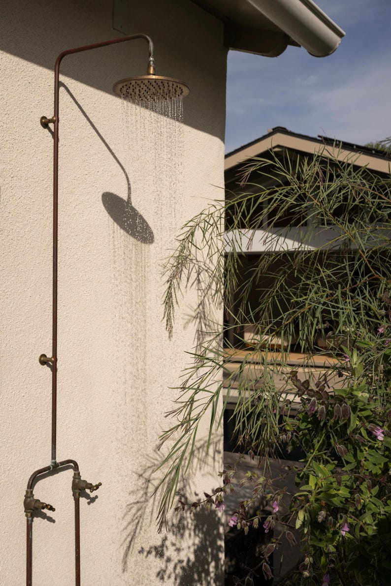 Rustic garden copper shower with dual hot and cold brass valves

