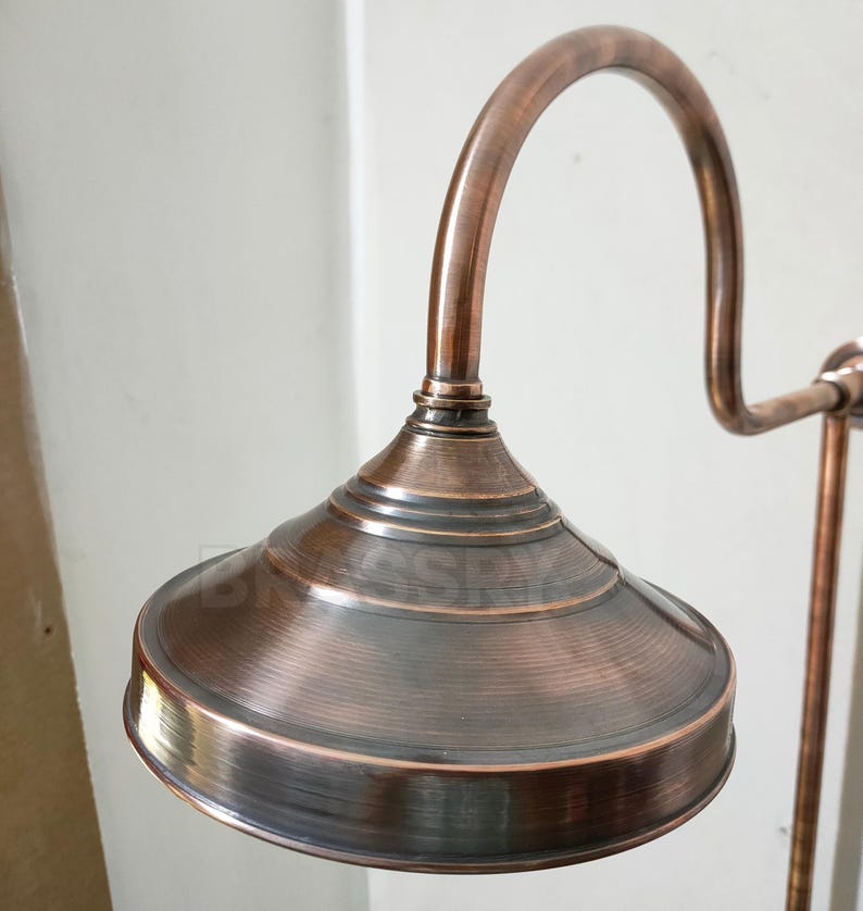 Rustic indoor bathroom with artisan-crafted copper shower system

