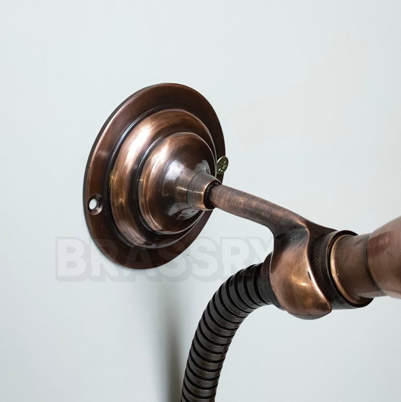 Antique brass and copper shower fixture with exposed piping

