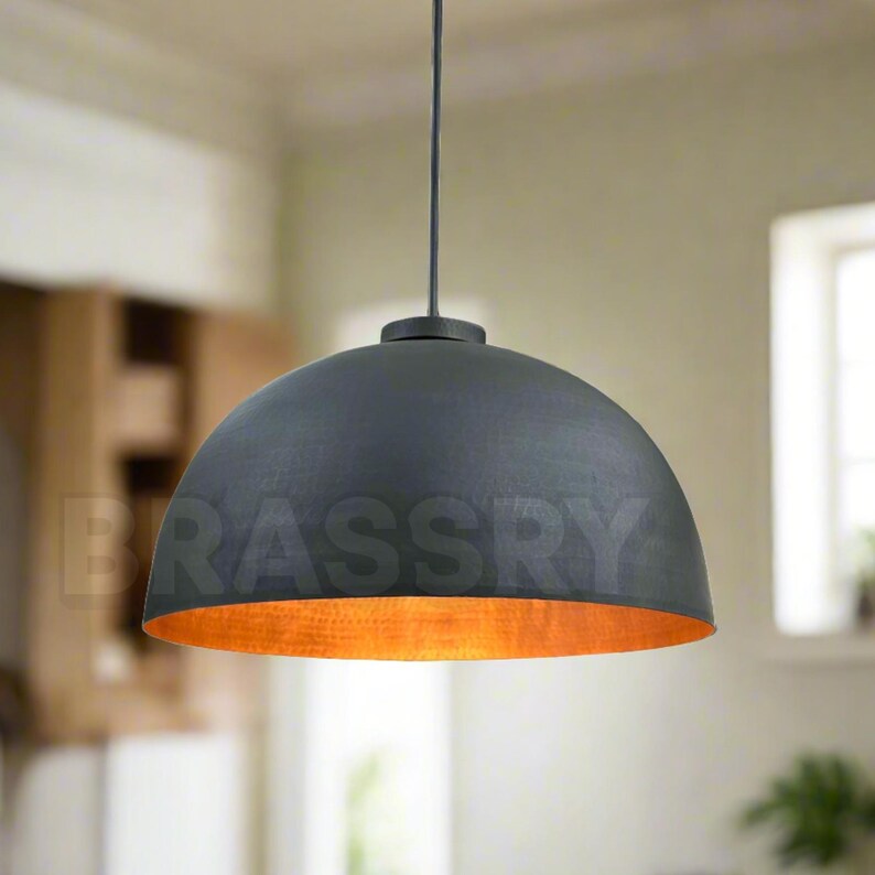 Warm amber glow from handcrafted black and copper light


