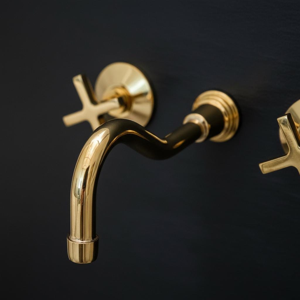 Gold faucet and handles on a black background