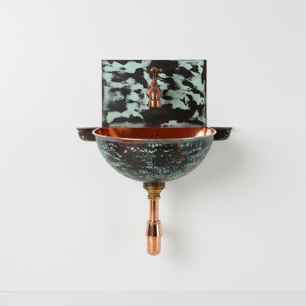 Wall-mounted copper sink with a decorative backsplash on a white background