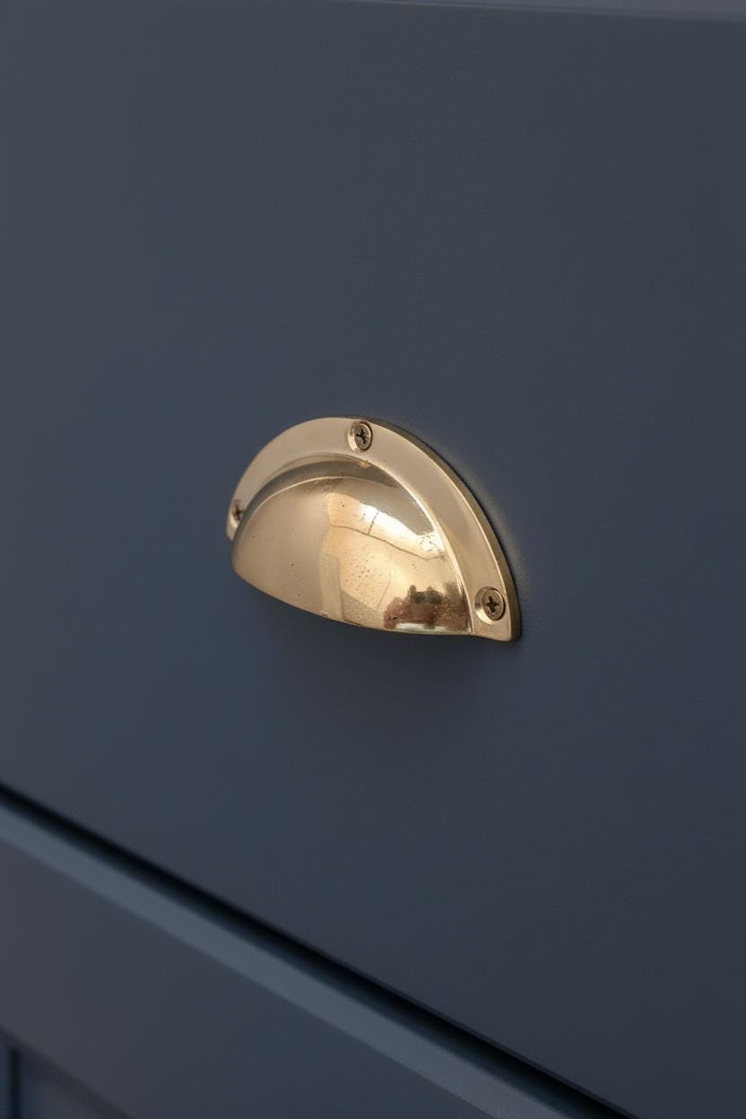 Gold handle on a dark blue cabinet