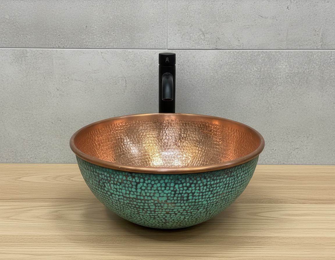 Copper and turquoise mosaic sink on a wooden surface with a gray tiled wall background