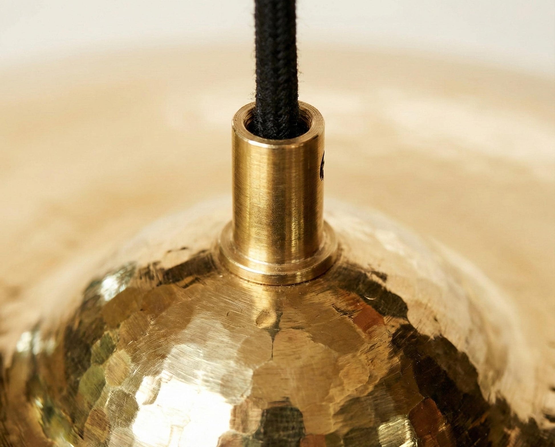 Close-up of a gold pendant light with a brass fitting.