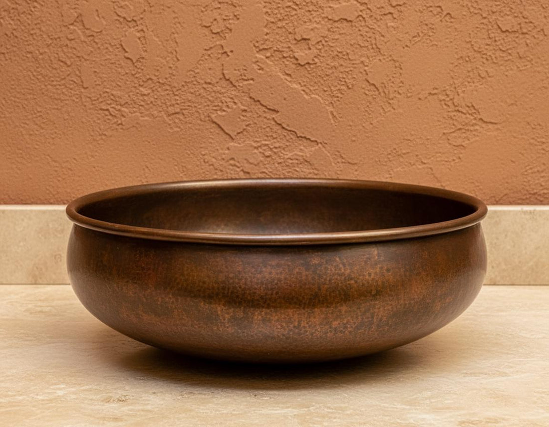 Copper sink on a stone surface with wooden panel background