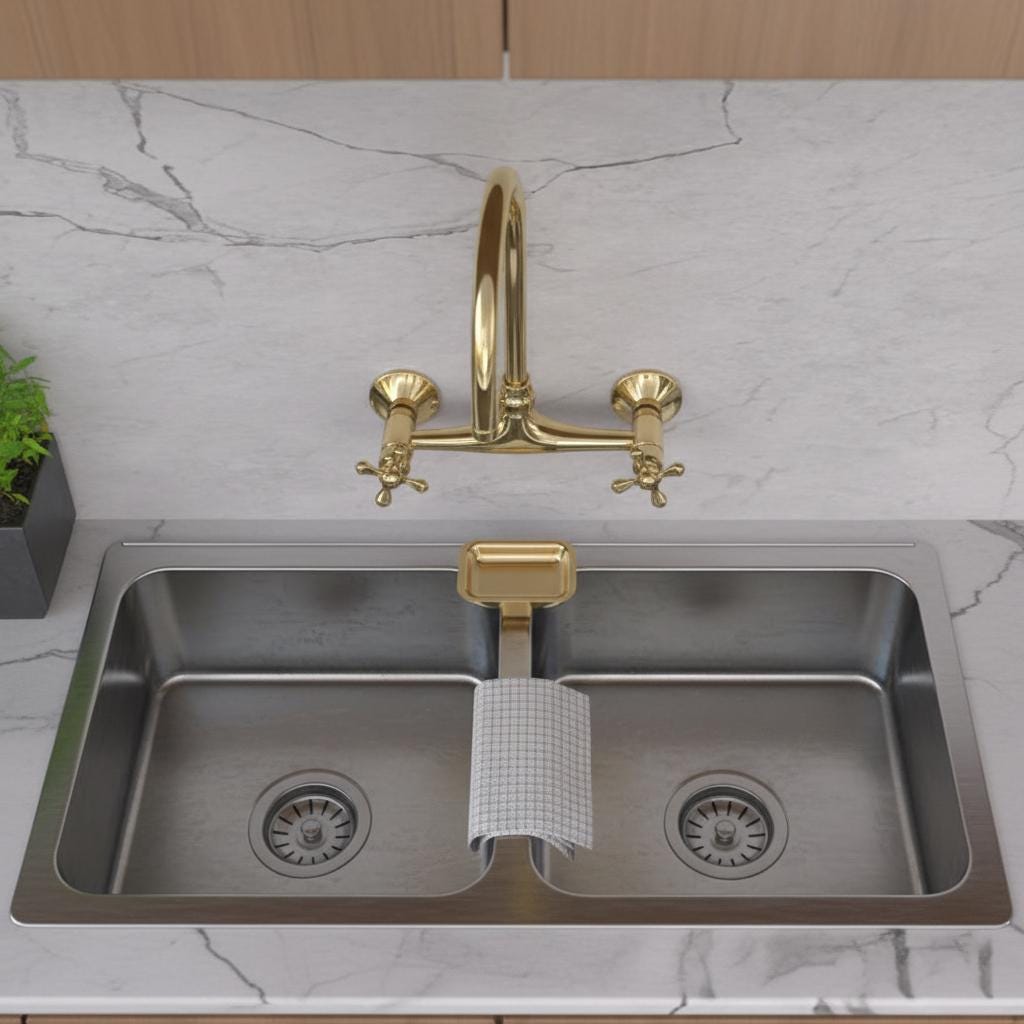 Kitchen sink with gold faucet on a marble countertop