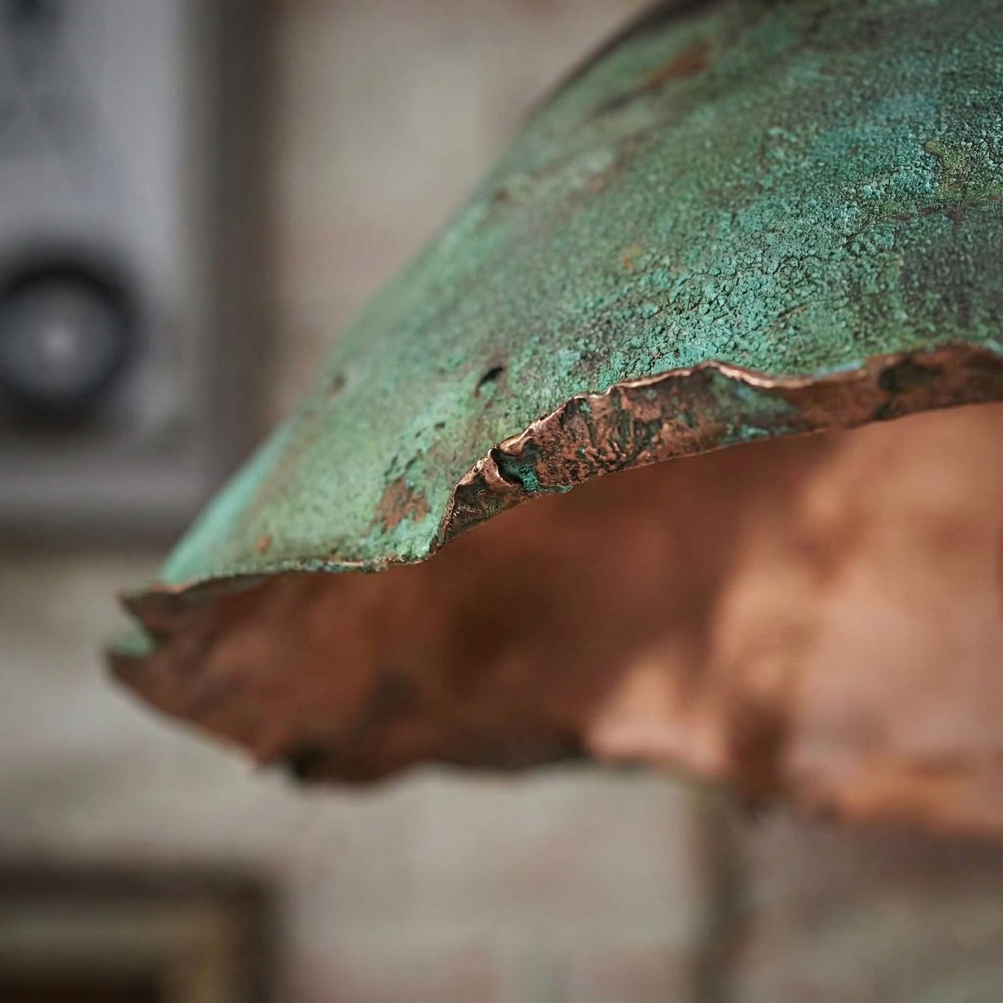 Close-up of a rusted metal surface with greenish patina.