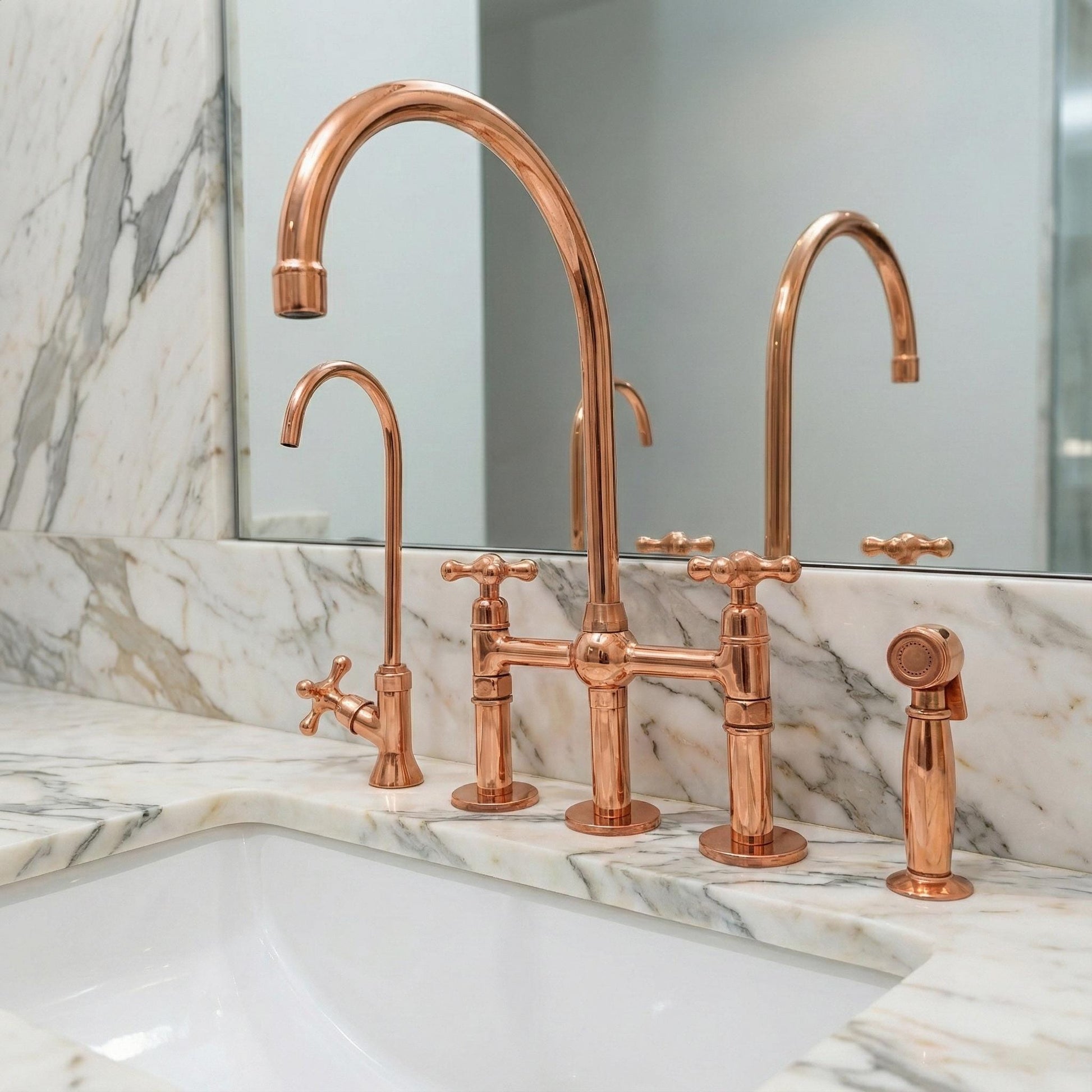 Copper kitchen faucet set on a marble countertop with a mirror in the background