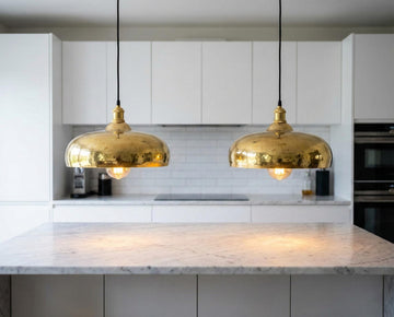 Modern kitchen with gold pendant lights and marble countertop