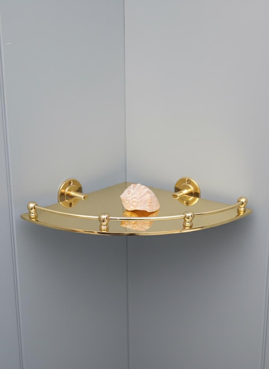 Gold corner shelf with decorative item on a gray wall