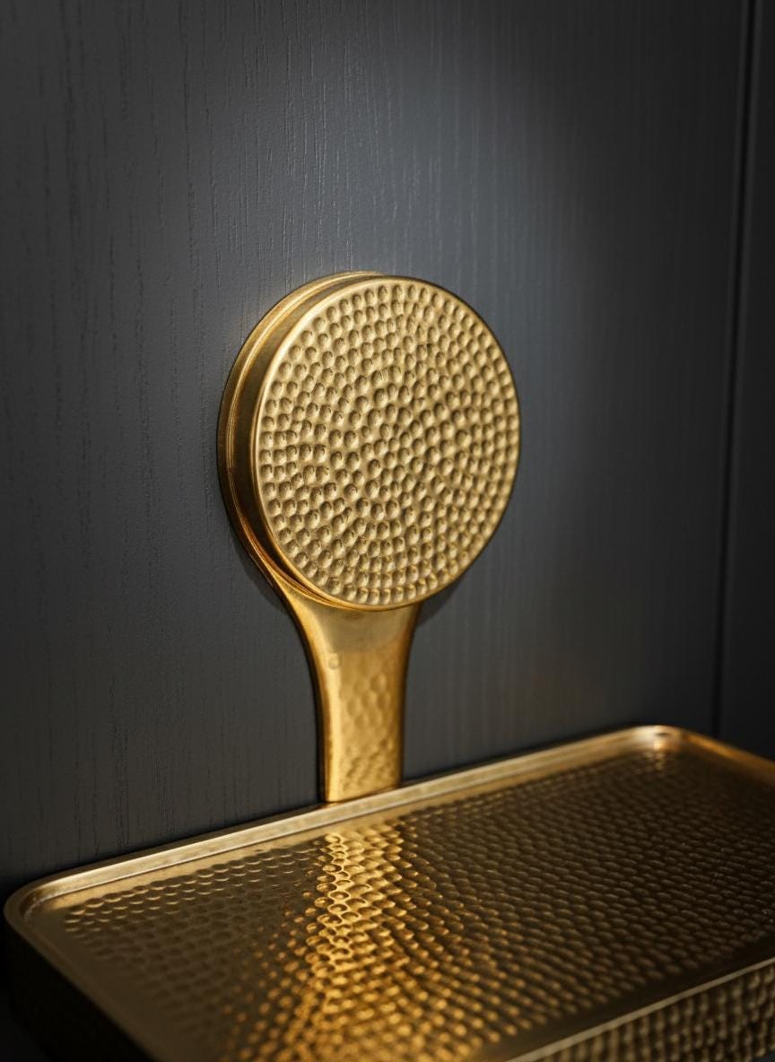Gold textured tray with a matching gold handle against a dark background